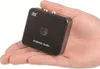 A hand holding a small black electronic device. Anteprima dell’immagine prodotto