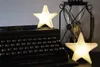 Two star-shaped lights are placed on a vintage typewriter next to a lantern. Produktbild-Vorschau