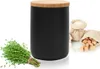 A black storage container with a wooden lid, a bunch of thyme, and two small burlap sacks filled with sugar cubes and granulated sugar. Produktbild-Vorschau
