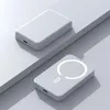 Two white power banks are displayed on a light gray surface with geometric shapes. Produktbild-Vorschau