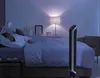 A person sleeping in a bed with a tower fan in the foreground. Produktbild-Vorschau