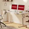A modern home office setup featuring a white standing desk with dual monitors, a chair, and storage. Podgląd zdjęcia produktu