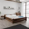 A bedroom scene with a wooden bed, nightstand, and dresser. Podgląd zdjęcia produktu