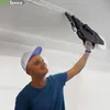 A man is applying joint compound to a ceiling seam with a specialized tool. Náhľad obrázku produktu