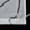 A close-up view of a white sheer curtain with a black abstract pattern and a white cord with a clear ring attached. Produktbild-Vorschau