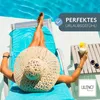 A person relaxing on a lounge chair by a pool with a drink. Produktbild-Vorschau