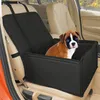 A puppy sits in a black car seat booster for pets, which is placed on the front passenger seat of a car. Anteprima dell’immagine prodotto