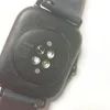 The back of a black smartwatch with sensors and text engravings. Voir les images du produit
