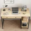 A computer desk with a laptop, books, and office supplies. Náhľad obrázku produktu