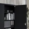 A close-up view of an open black metal filing cabinet filled with books and binders. Voir les images du produit
