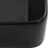 A close-up view of the corner of a black ceramic sink. Náhled obrázku produktu