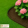 A garden bed with a dark brown border separating it from green grass, featuring pink hydrangeas. Produktbild-Vorschau