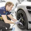 A man is checking the tire pressure of a car. Náhľad obrázku produktu