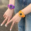 Two people wearing colorful digital watches. Produktbild-Vorschau