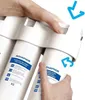 Hands are shown replacing a water filter cartridge in a water filtration system. Anteprima dell’immagine prodotto
