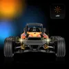 Front view of an orange and black remote control car with its headlights on, against a dark blue and orange gradient background. Anteprima dell’immagine prodotto