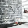 A kitchen sink area with a faucet in use, showing water flowing into the sink. Náhled obrázku produktu