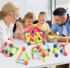 A family is playing with magnetic building blocks. Voir les images du produit