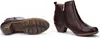 A pair of brown leather ankle boots shown from two angles: one showing the sole and the other showing the side with a zipper. Voir les images du produit