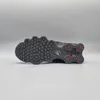 The image shows the sole of a black Nike Shox TL sneaker with red accents. Produktbild-Vorschau