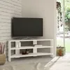 A white corner TV stand with a TV on it, placed in a room with a brick wall and a window. Produktbild-Vorschau
