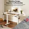 A white standing desk with a monitor, keyboard, and other office accessories. Produktbild-Vorschau