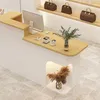 A reception desk in a retail store with a computer, payment terminals, and decorative plants. Produktbild-Vorschau