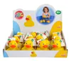 A display box filled with rubber ducks, with a picture of a child playing with ducks in the background. Anteprima dell’immagine prodotto
