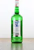 A green glass bottle of Malteserkreuz Aquavit is shown against a white background, standing on a wooden surface. Produktbild-Vorschau