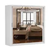 A white wardrobe with mirrored doors reflecting a bedroom interior. Produktbild-Vorschau
