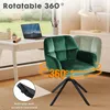 A green velvet chair is shown next to a desk with a laptop, in a room with a window overlooking a garden. Voir les images du produit