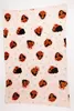 A flat lay of a pink blanket with a repeating pattern of cartoon characters. Produktbild-Vorschau