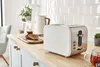 A kitchen counter with a toaster, kettle, and toast. Podgląd zdjęcia produktu