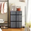 A storage unit with fabric drawers and clothing on a rack. Anteprima dell’immagine prodotto