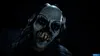 A close-up of a scary mask with sharp teeth and dark hair against a black background. Produktbild-Vorschau
