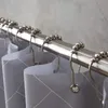 A close-up view of a shower curtain rod with shower curtain hooks and a shower curtain. Produktbild-Vorschau