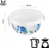 A round glass food container with a lid, decorated with blue flowers and green leaves. Dimensions and capacity are indicated. Produktbild-Vorschau