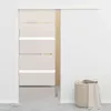 A sliding door in a room with a laundry basket in the corner. Náhled obrázku produktu