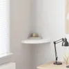A corner shelf with a few decorative items on it, next to a window and a desk lamp. Produktbild-Vorschau