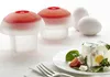 Two egg molds and a plate with a prepared dish are arranged on a white surface. Podgląd zdjęcia produktu