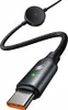 A black USB-C charging cable with a circular magnetic adapter on one end and a USB-C connector on the other. A small green LED is visible on the USB-C connector. Podgląd zdjęcia produktu