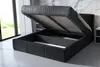 A black upholstered bed frame with the mattress base lifted to reveal storage space underneath. Produktbild-Vorschau