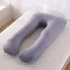 A U-shaped pregnancy pillow lies on a mattress. Náhled obrázku produktu