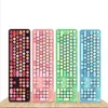 Four colorful keyboards are lined up on a wooden surface against a white background. Náhled obrázku produktu
