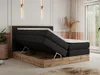 A bedroom scene featuring a king-size boxspring bed with its storage compartment open, showcasing the interior and mattress. Produktbild-Vorschau