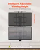 A motorized TV lift stand is shown mounted on a wall, with two TVs at different heights to demonstrate adjustable viewing. Produktbild-Vorschau