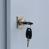 A close-up of a lock with two keys inserted and hanging from it. Produktbild-Vorschau