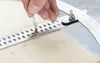 A hand is using a marking gauge with a pencil on a wooden surface. Anteprima dell’immagine prodotto