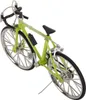 A close-up, studio shot of a miniature green bicycle model. Produktbild-Vorschau