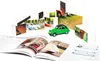 A collection of building blocks with car images, a green toy car, and an open book with car illustrations. Produktbild-Vorschau